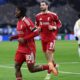 Dominik Szoboszlai and Jeremie Frimpong run on the pitch in red Liverpool kit