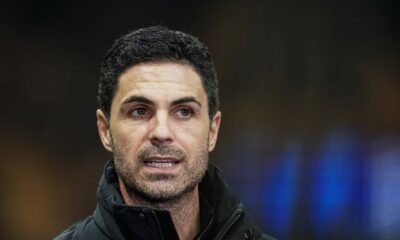 Mikel Arteta looks on.