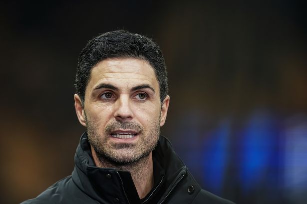 Mikel Arteta looks on.