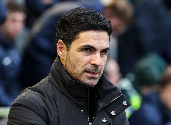 Mikel Arteta sitting in the dugout.