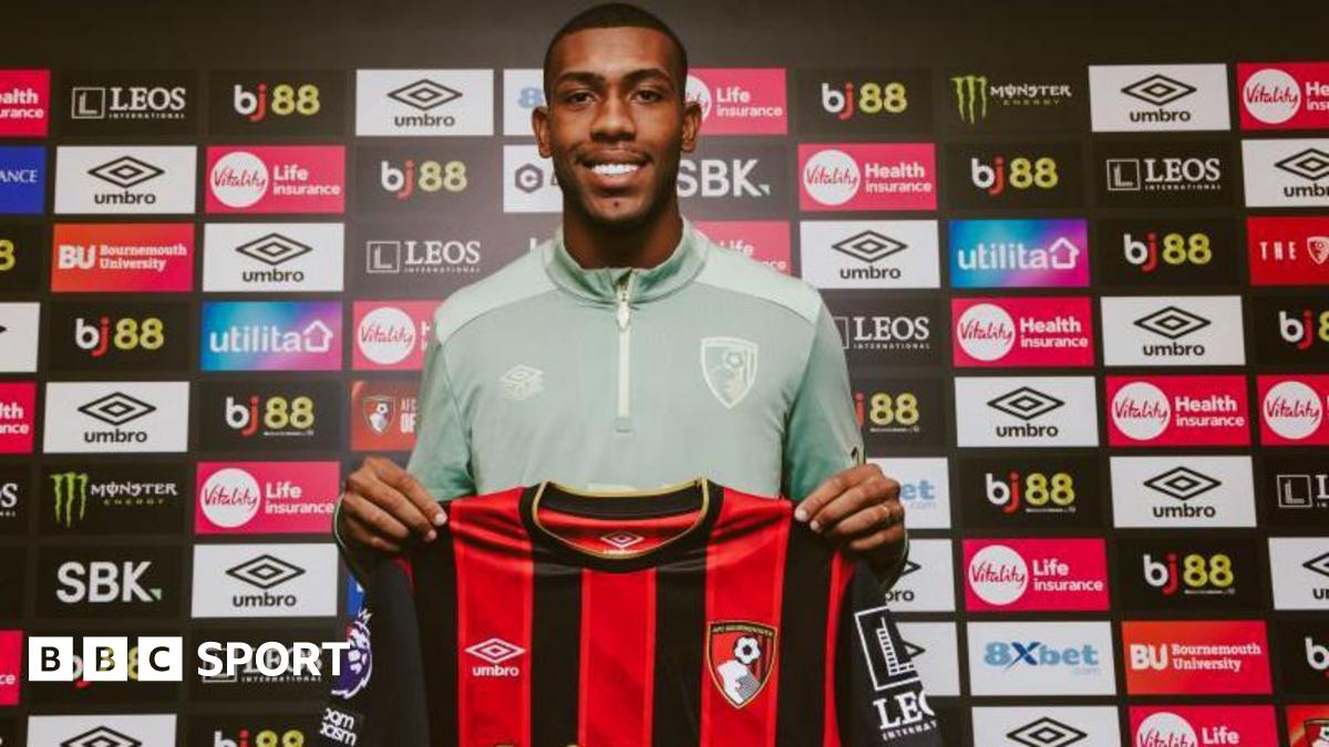 Rayan holding a Bournemouth shirt