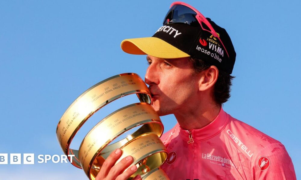Simon Yates with the Giro d'Italia trophy in 2025