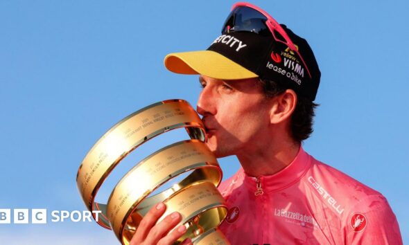 Simon Yates with the Giro d'Italia trophy in 2025