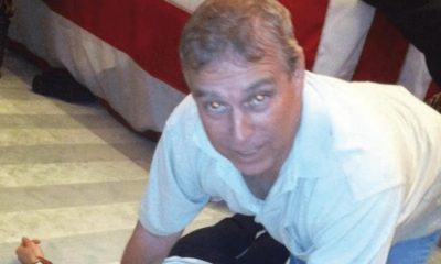 Andrew 'pictured crouched over woman' in Epstein files