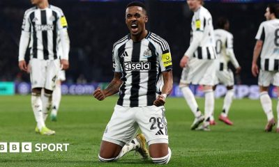 Joe Willock is on his knees and clenching his fists to celebrate scoring a goal