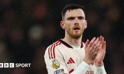 Liverpool left-back Andy Robertson applauds the fans
