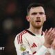 Liverpool left-back Andy Robertson applauds the fans