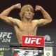 Paddy Pimblett flexes his muscles as he weighs in