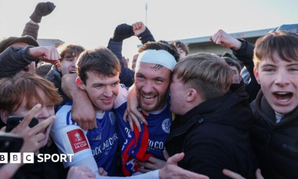 Paul Dawson of Macclesfield celebrates with team-mate Luke Duffy and fans after the team's victory over Crystal Palace