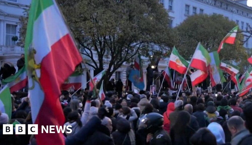 Protester climbs onto balcony of Iranian embassy in London