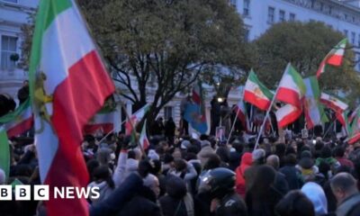 Protester climbs onto balcony of Iranian embassy in London