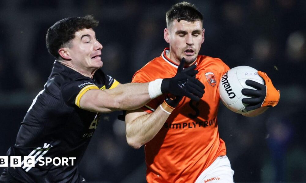 Armagh's Greg McCabe is challenged by James Guinness