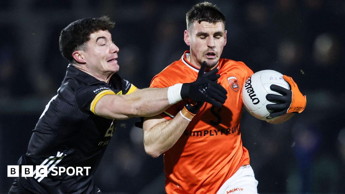 Armagh's Greg McCabe is challenged by James Guinness