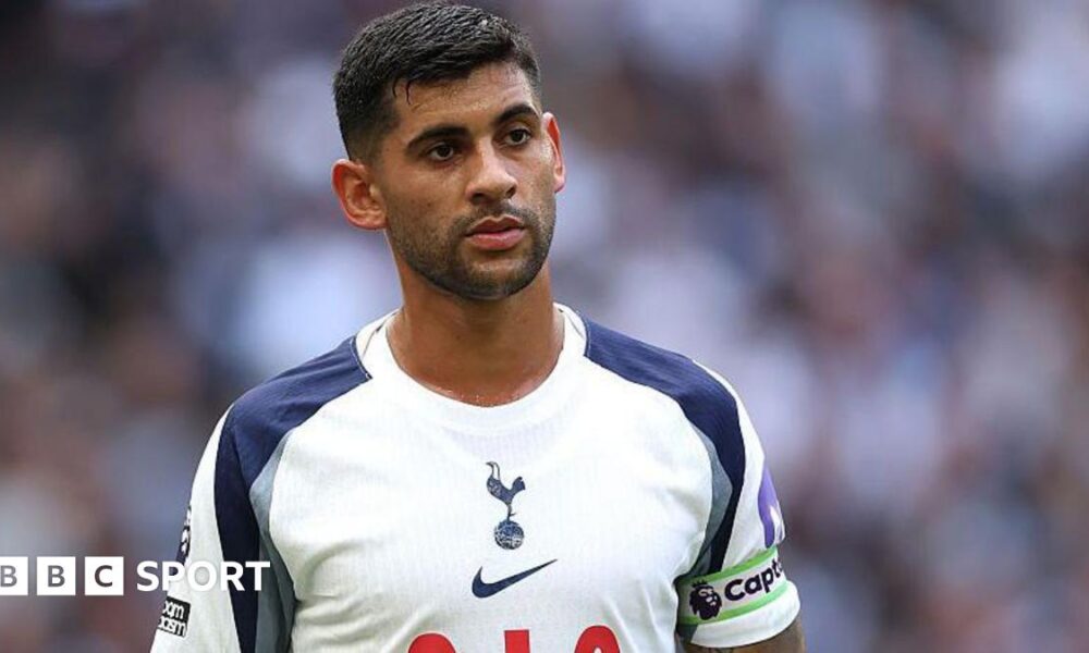Cristian Romero wearing a white Tottenham matchday shirt