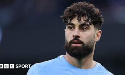 Luke Littler celebrates winning the 2026 PDC World Championship as tickertape falls