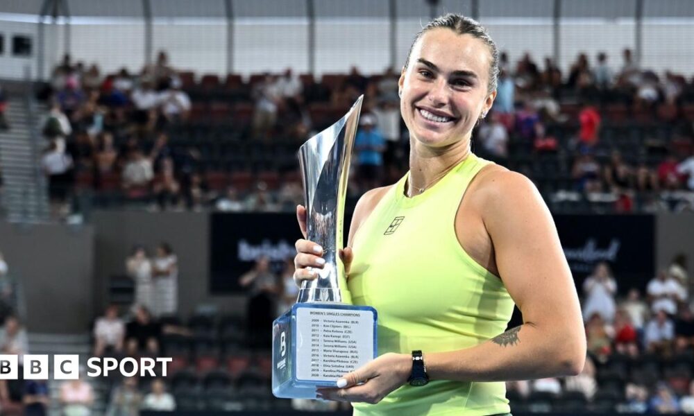 Aryna Sabalenka holds the trophy after winning the Brisbane International