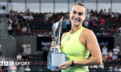 Aryna Sabalenka holds the trophy after winning the Brisbane International