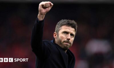 Michael Carrick raises his fist in celebration to Manchester United fans after their win over Manchester City