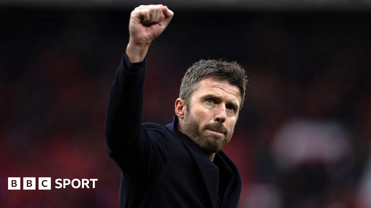 Michael Carrick raises his fist in celebration to Manchester United fans after their win over Manchester City