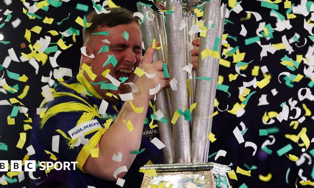 Luke Littler celebrates winning the 2026 PDC World Championship as tickertape falls
