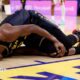 Golden State Warriors forward Jimmy Butler lies on the floor in agony, holding his right knee after tearing his ACL