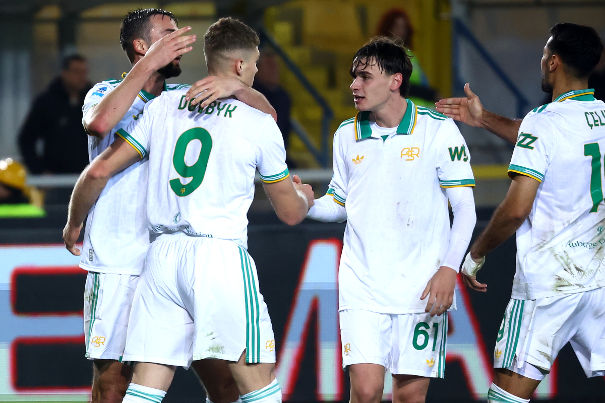 LECCE, ITALY - JANUARY 06: Artem Dobvyk of AS Roma celebrates with their teammates after scoring his team