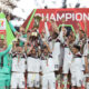 ROME, ITALY - MAY 14: Lewis Ferguson, Lorenzo De Silvestri and Riccardo Orsolini of Bologna lift the Coppa Italia trophy as their team mates celebrate after the team's victory in the Coppa Italia Final match between AC Milan and Bologna at Stadio Olimpico on May 14, 2025 in Rome, Italy. (Photo by Paolo Bruno/Getty Images)