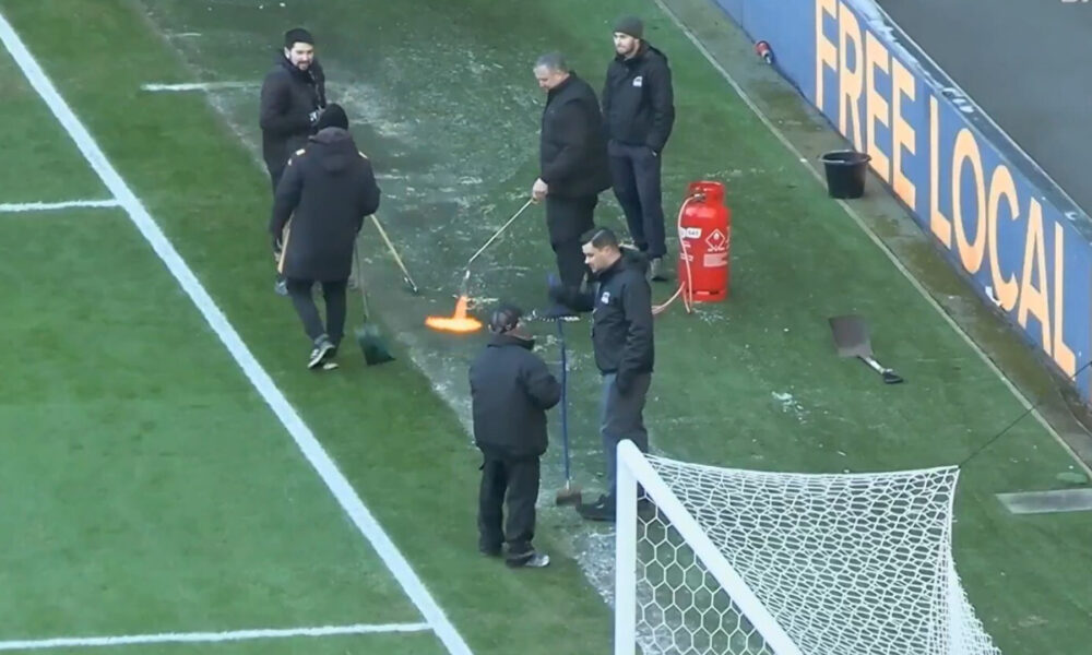 Bizarre moment groundsmen use BLOWTORCH to desperately thaw pitch before EFL clash is controversially postponed