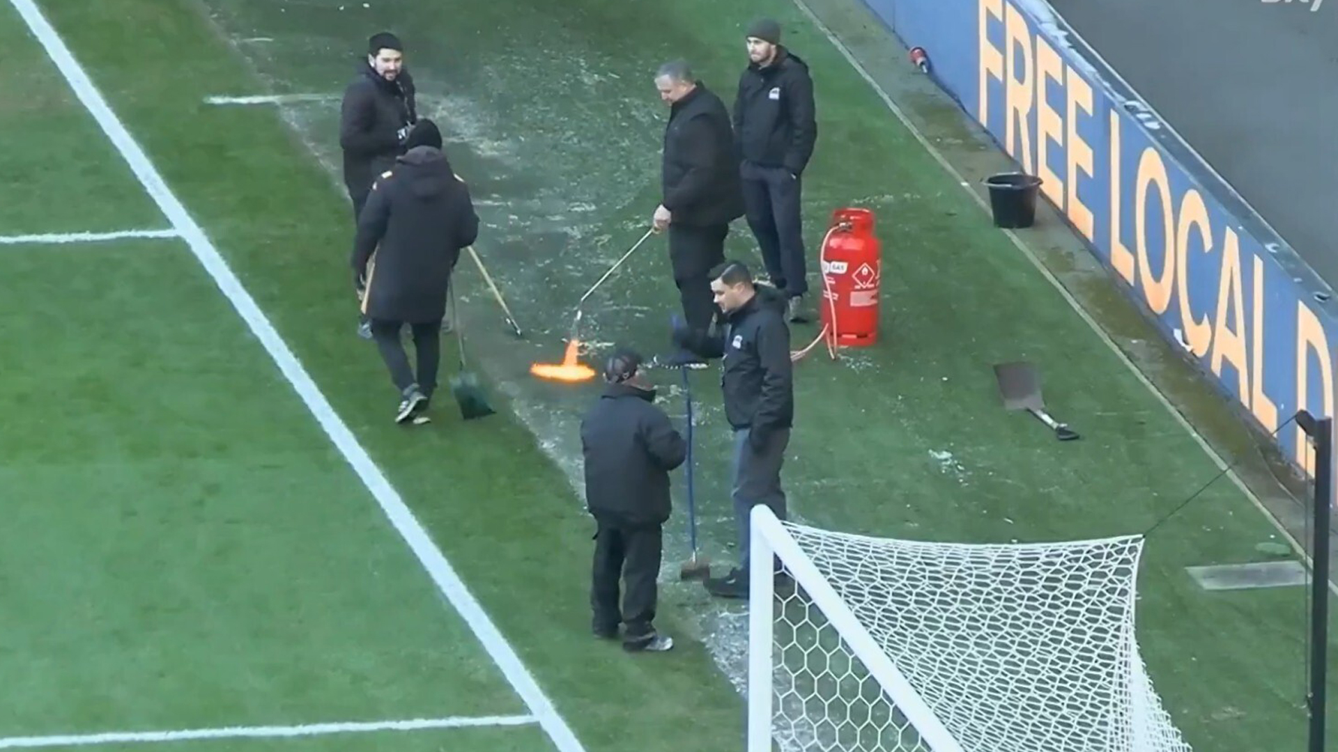 Bizarre moment groundsmen use BLOWTORCH to desperately thaw pitch before EFL clash is controversially postponed