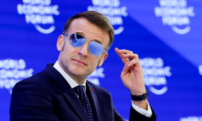 French President Macron wearing sunglasses indoors at Davos