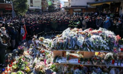 Grieving Swiss town holds silent procession for victims of deadly bar fire
