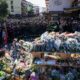 Grieving Swiss town holds silent procession for victims of deadly bar fire