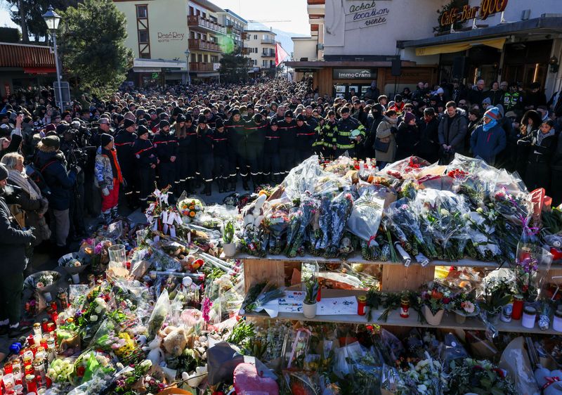 Grieving Swiss town holds silent procession for victims of deadly bar fire