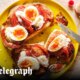 Big toast with roast tomatoes, jammy eggs, mayo and hot sauce