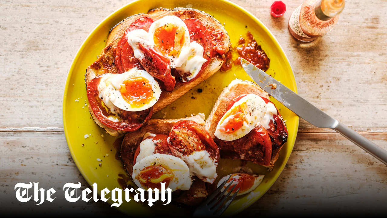 Big toast with roast tomatoes, jammy eggs, mayo and hot sauce
