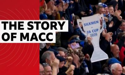 Macclesfield FC fans holding a cardboard cut-out FA Cup