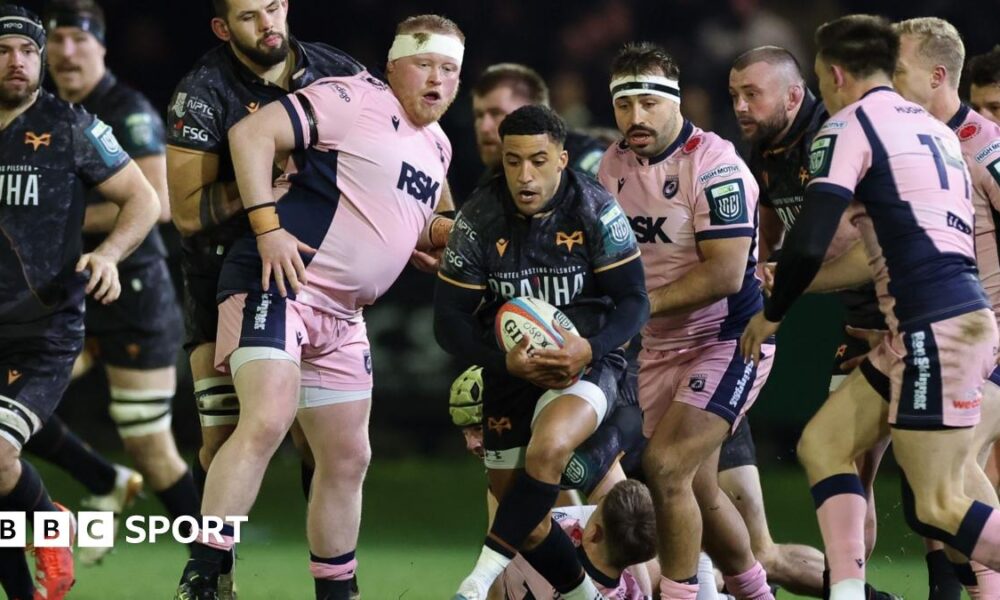 Keelan Giles of Ospreys has the ball surrounded by Cardiff players