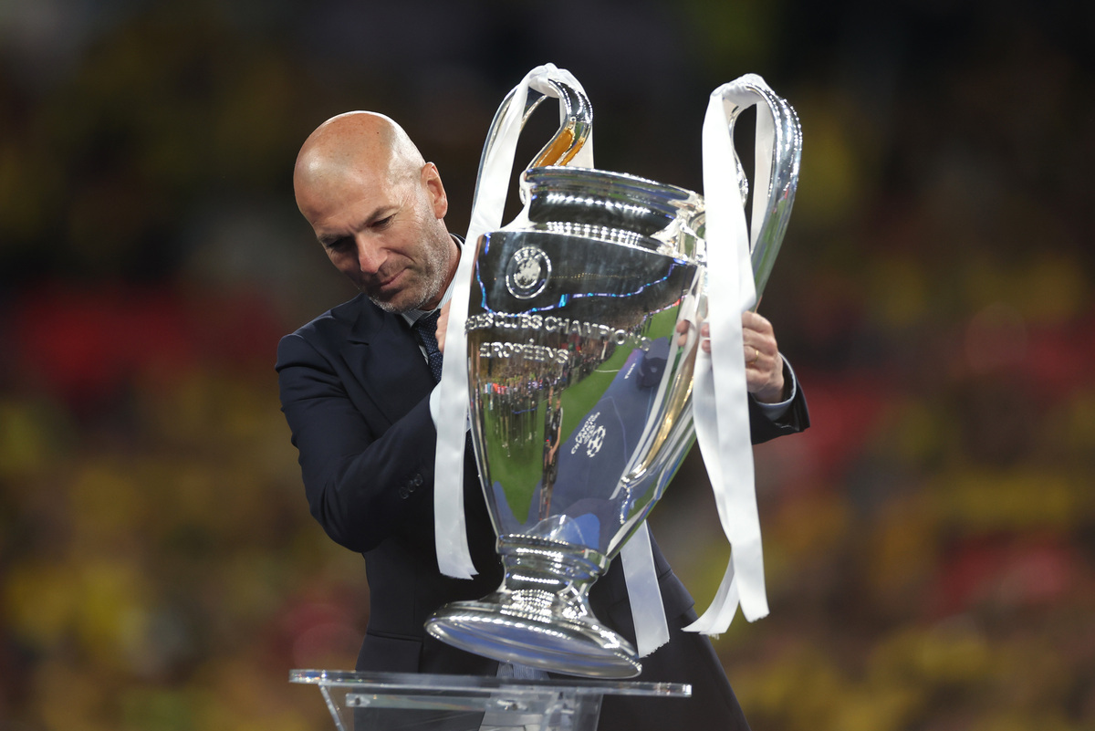 LONDON, ENGLAND - JUNE 01:Former Real Madrid and Juventus star Zinedine Zidane places the Champions League Trophy onto the plinth after the UEFA Champions League 2023/24 Final match between Borussia Dortmund and Real Madrid CF at Wembley Stadium on June 01, 2024 in London, England. (Photo by Lars Baron/Getty Images)