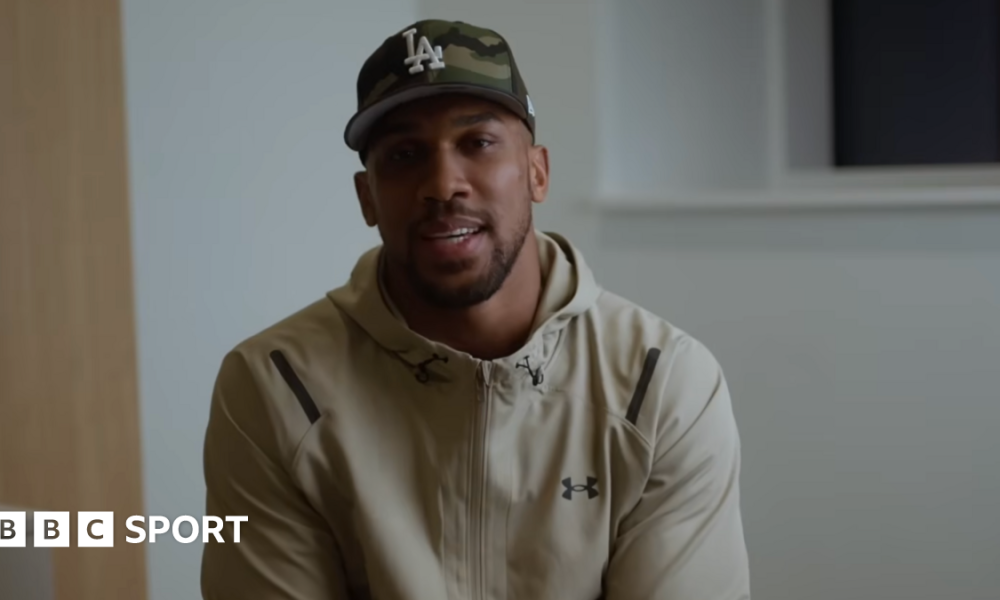 Anthony Joshua sits in front of a camera for a Youtube video