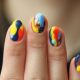 woman shows brightly colors marbled nails almost like tie-dye