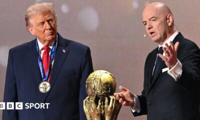US President Donald Trump (left) and Fifa president Gianni Infantino (right) either side of the World Cup trophy at the 2026 tournament draw