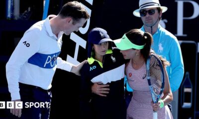 Turkey's Zeynep Sonmez assists a ball kid after she fainted during Sonmez's women's singles match against Russia's Ekaterina Alexandrova