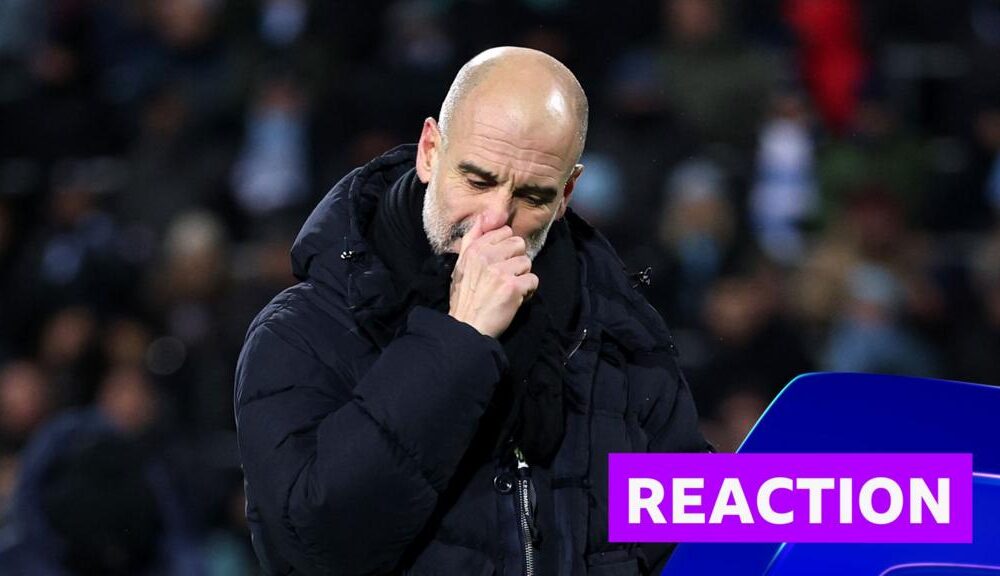 Pep Guardiola looks disappointed in black coat