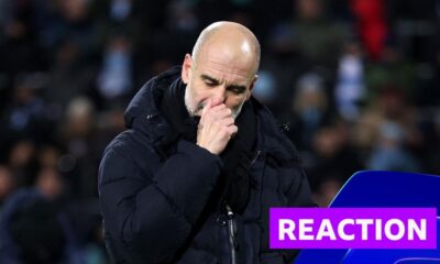 Pep Guardiola looks disappointed in black coat