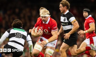 Wales' Aaron Wainwright runs with the ball against the Barbarians