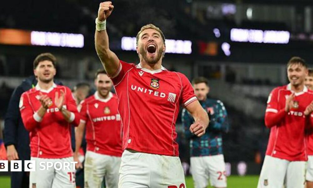 Luke Littler celebrates winning the 2026 PDC World Championship as tickertape falls