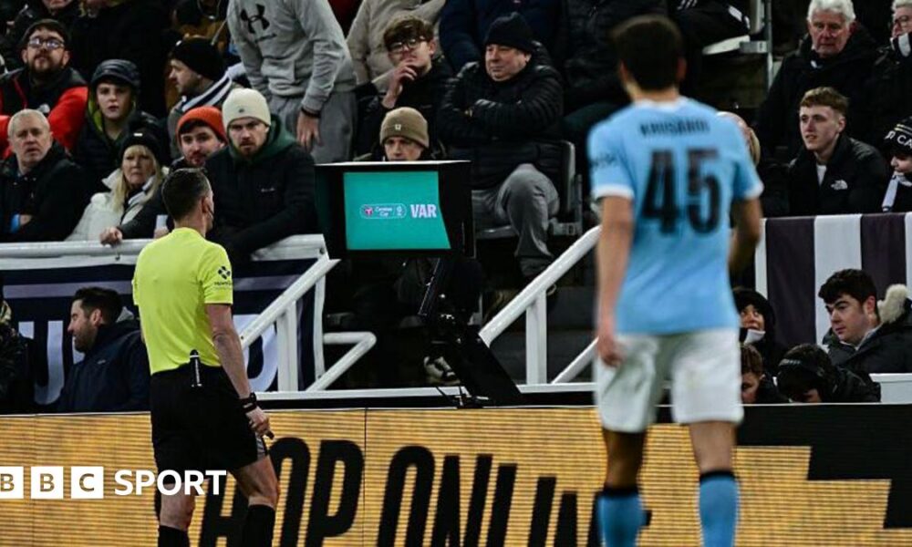 Chris Kavanagh at the pitch-side VAR monitor
