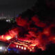 Moment warehouses burn in huge blaze as 50 firefighters battle inferno engulfing buildings & setting off explosions