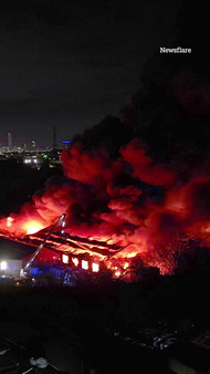Moment warehouses burn in huge blaze as 50 firefighters battle inferno engulfing buildings & setting off explosions