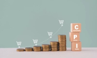 CPI, consumer price index concept. Wooden block with CPI word and stack of coins and increasing graph with shopping cart icon. Goods price inflation and inflation rising. Impact on economic growth
